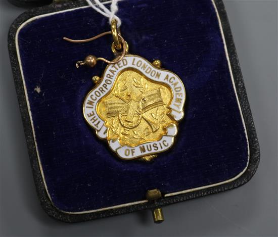 A 9ct gold and enamel medallion and two yellow metal earring wires.